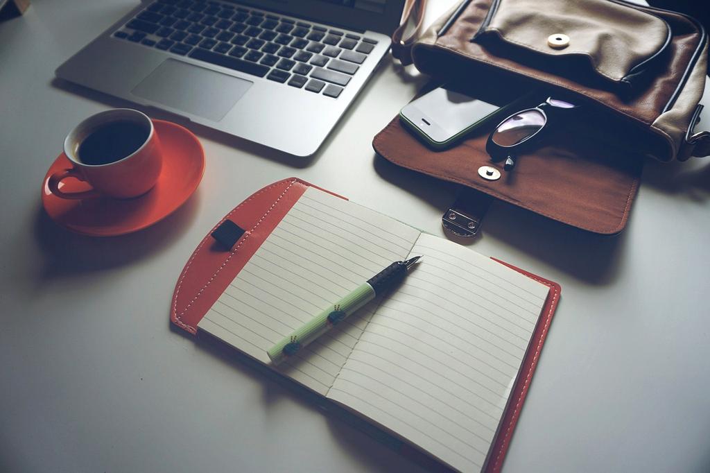 Hands typing on ergonomic keyboard with headset nearby